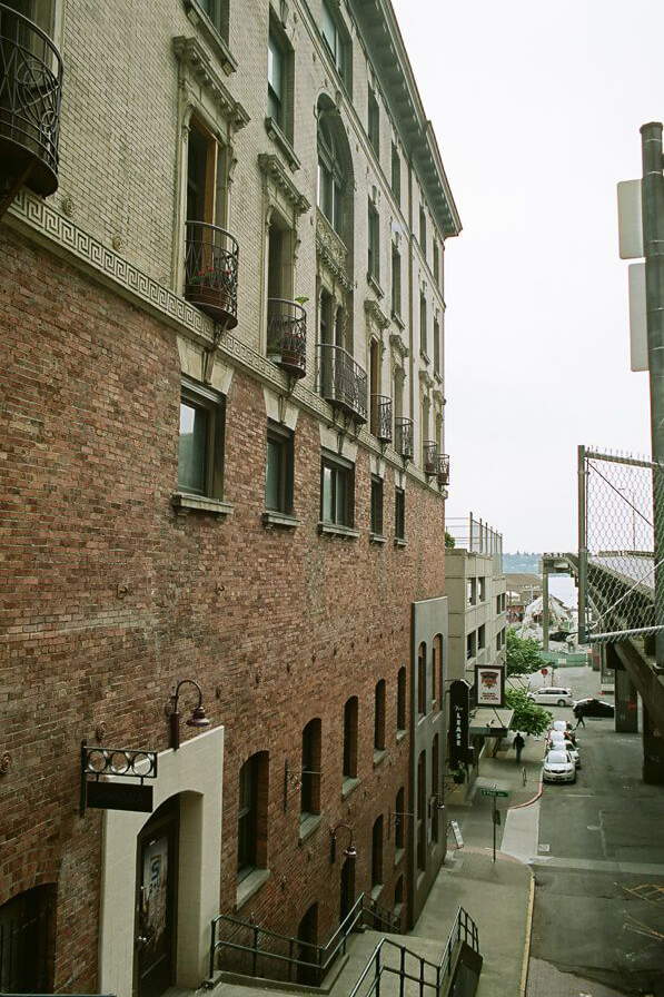 The side of a brick apartment building with small windows