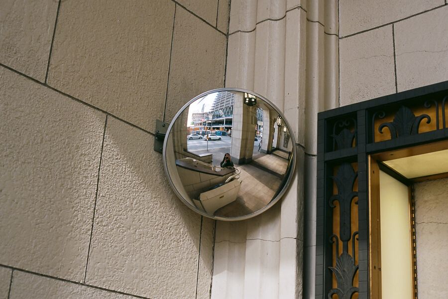 Mirror selfie in a circular convex mirror on the street