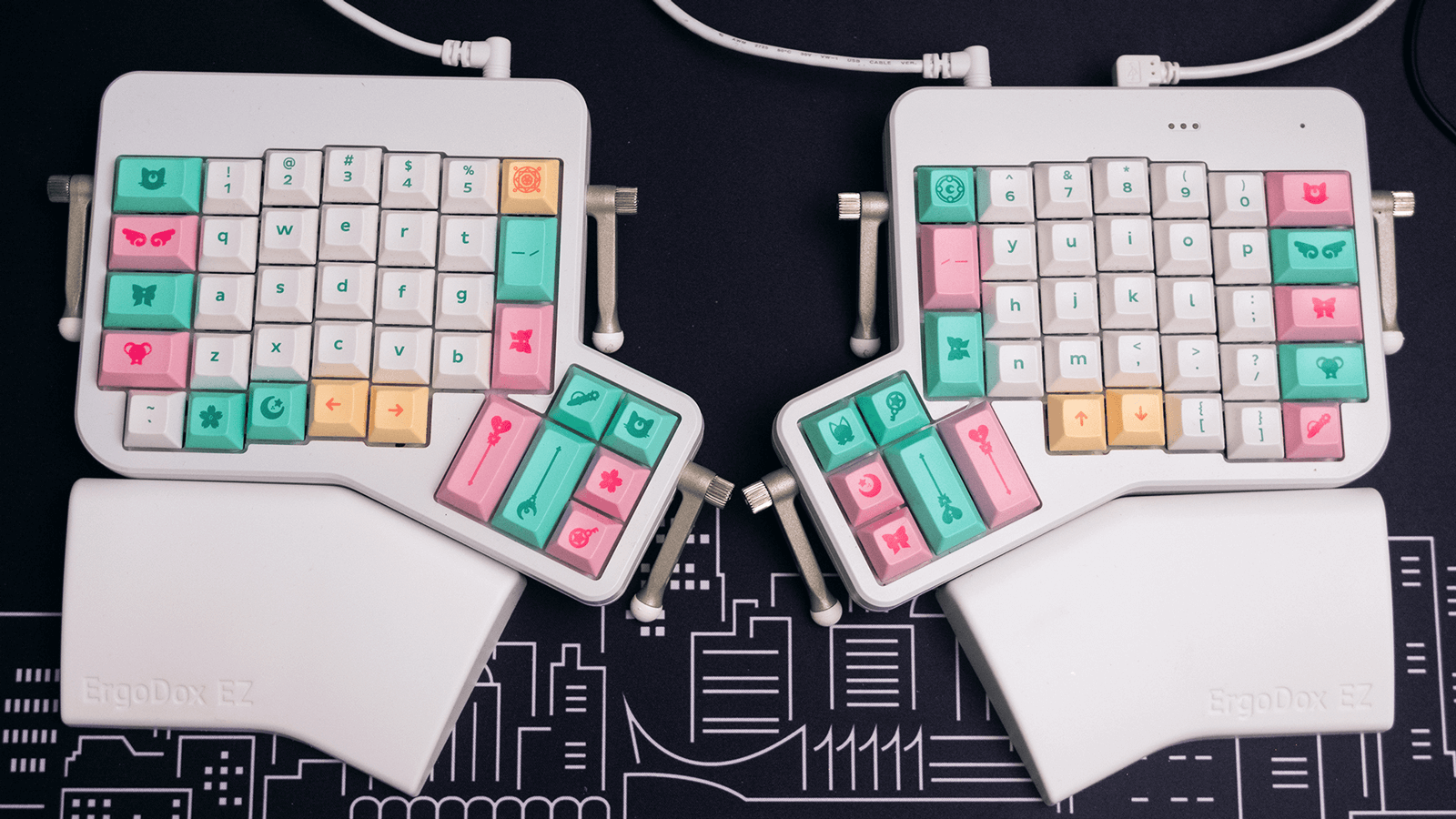 Overhead shot of my Ergodox split keyboard with white, pink, and mint keycaps.