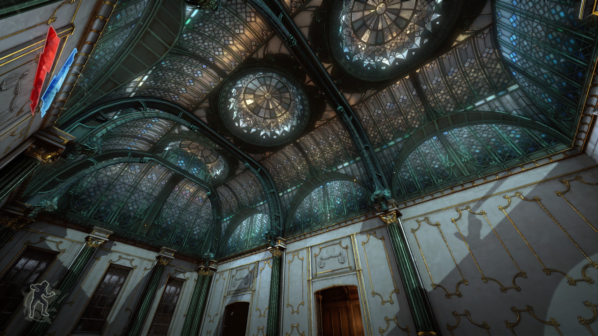 A fancy, stained glass dome roof in a big house.