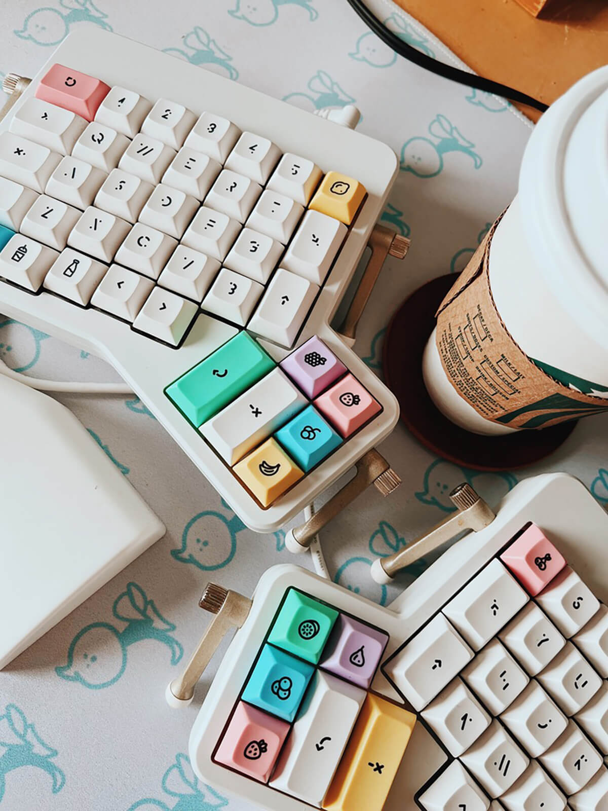 My white split keyboard and a Starbucks coffee cup on my desk.