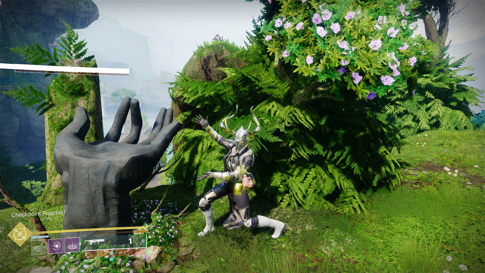 My guardian emoting a 'tada!' pose, arms outstretched, next to a statue of a disembodied hand with six fingers.