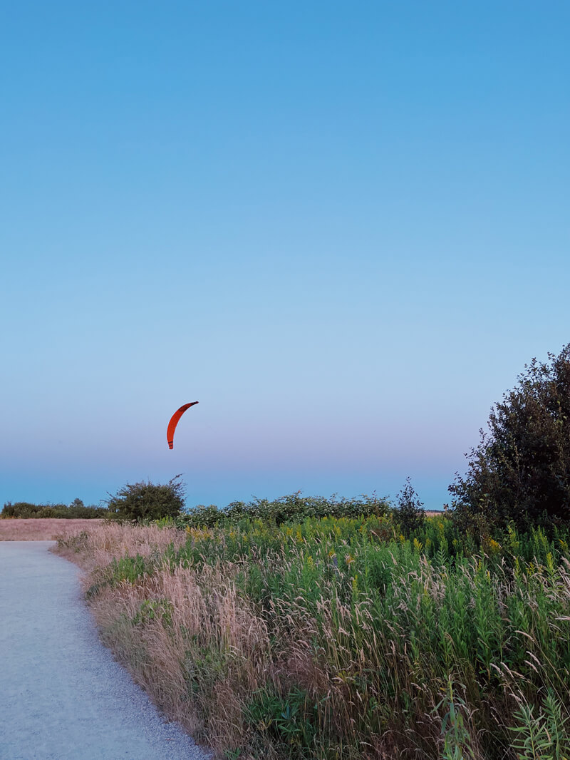 A red glider against a purple sky.