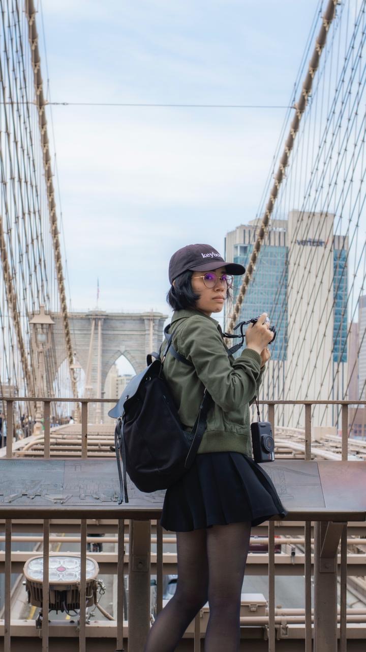 Me, holding two cameras on the Brooklyn Bridge.