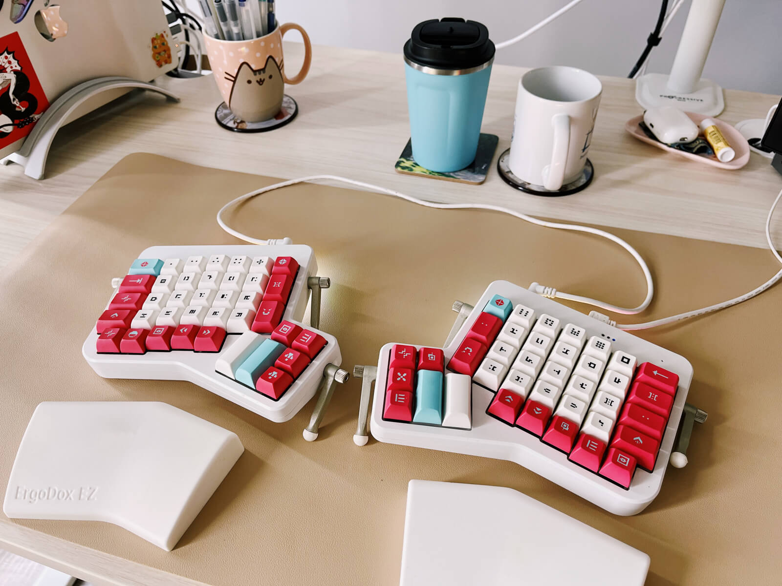 Closeup of my white split keyboard with white, red and blue keycaps.