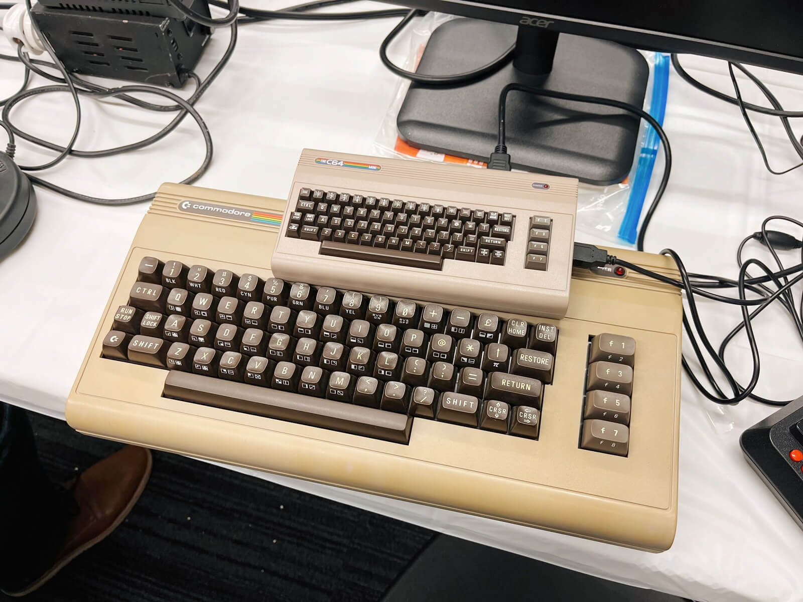 A Commodore 64 and a smaller Commodore model about a quarter of the size, labeled ‘Mini’.