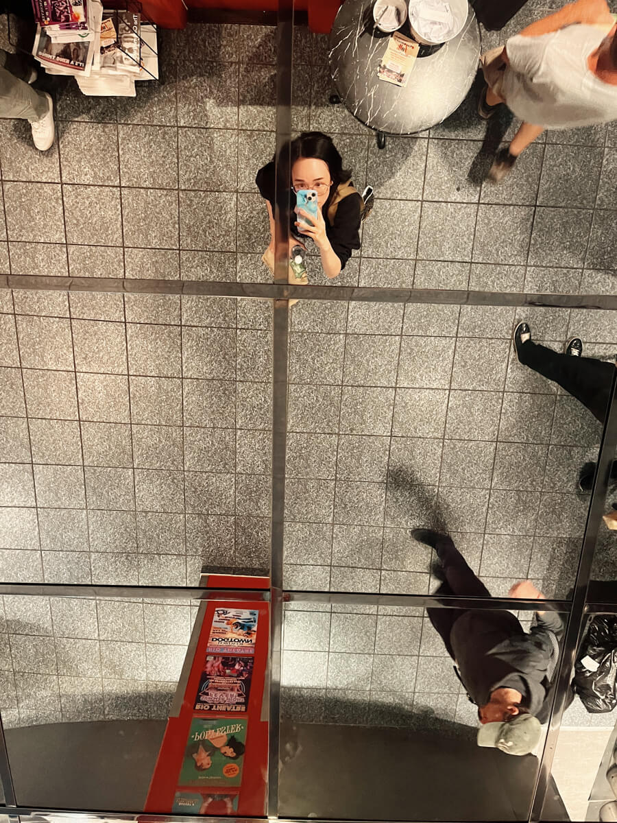 Mirror selfie, but the mirror is in the ceiling. I'm standing in a theatre lobby.