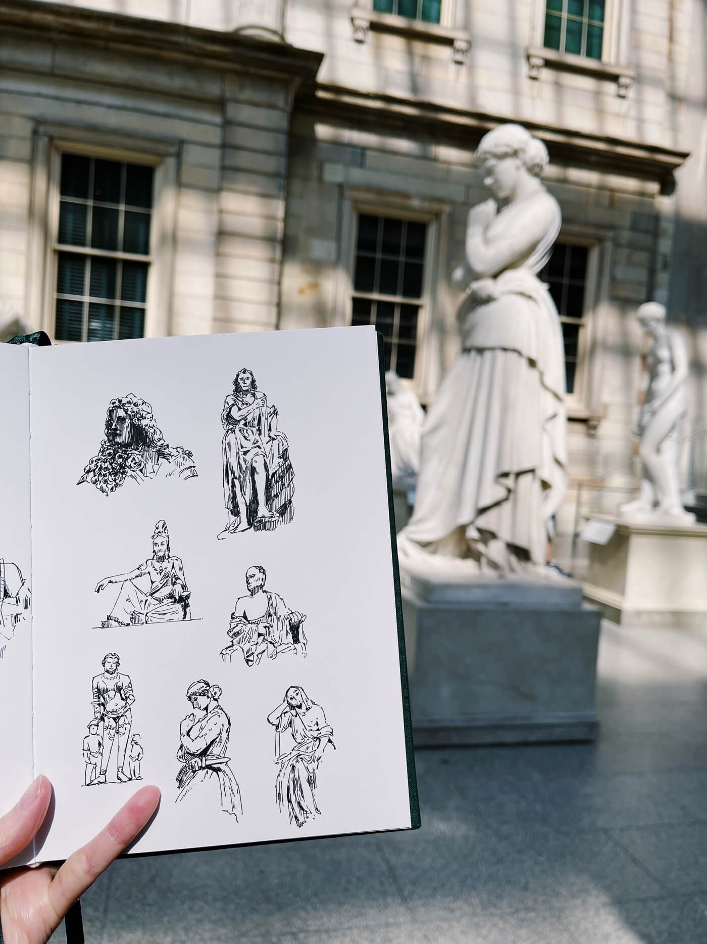 Sketchbook in the American Wing at the Met, showing various sketches of sculptures.