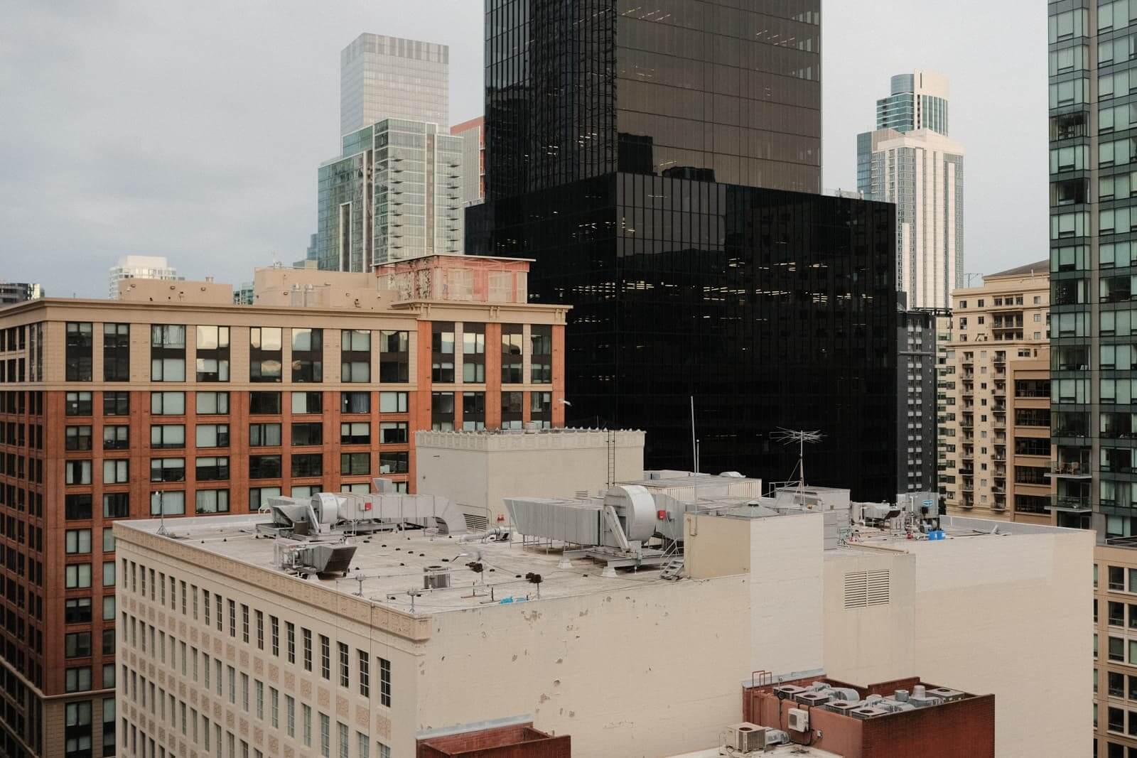 City view from the museum upper floor. One of the buildings is black and stands out in the skyline.