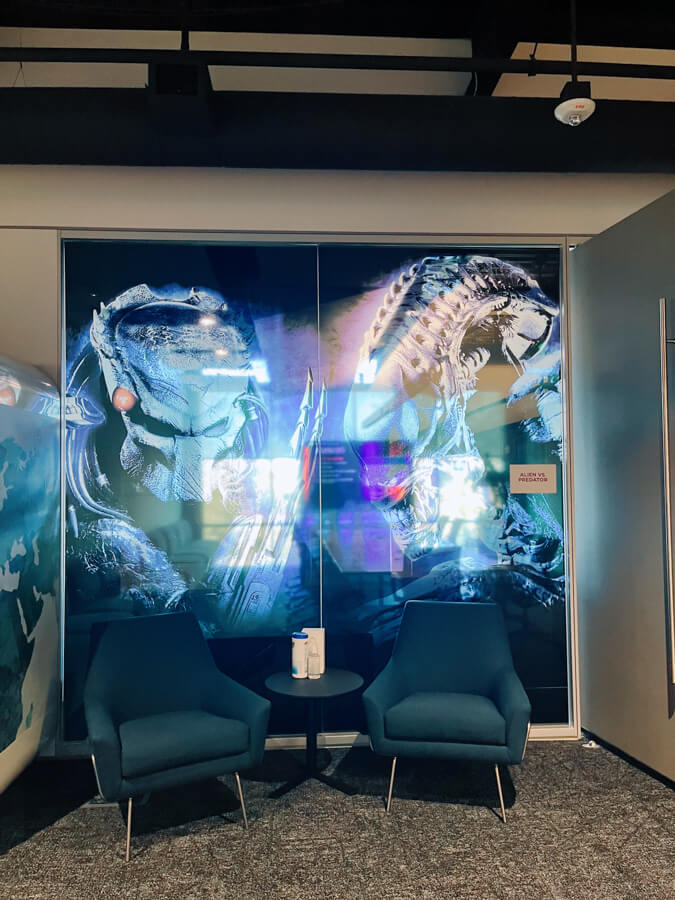 A meeting room with art of Alien vs Predator on the glass.
