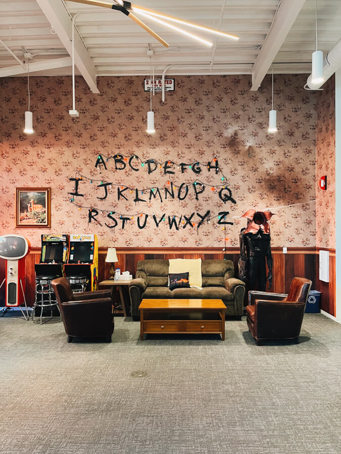 A Stranger Things set with the letters on string lights on the wall.