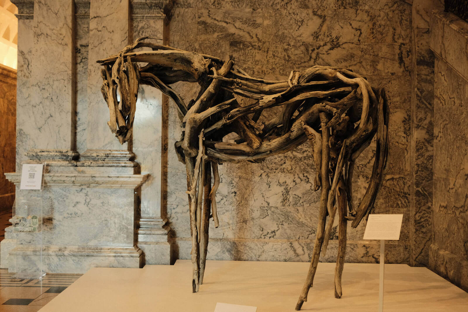 A large sculpture of a horse made out of driftwood.